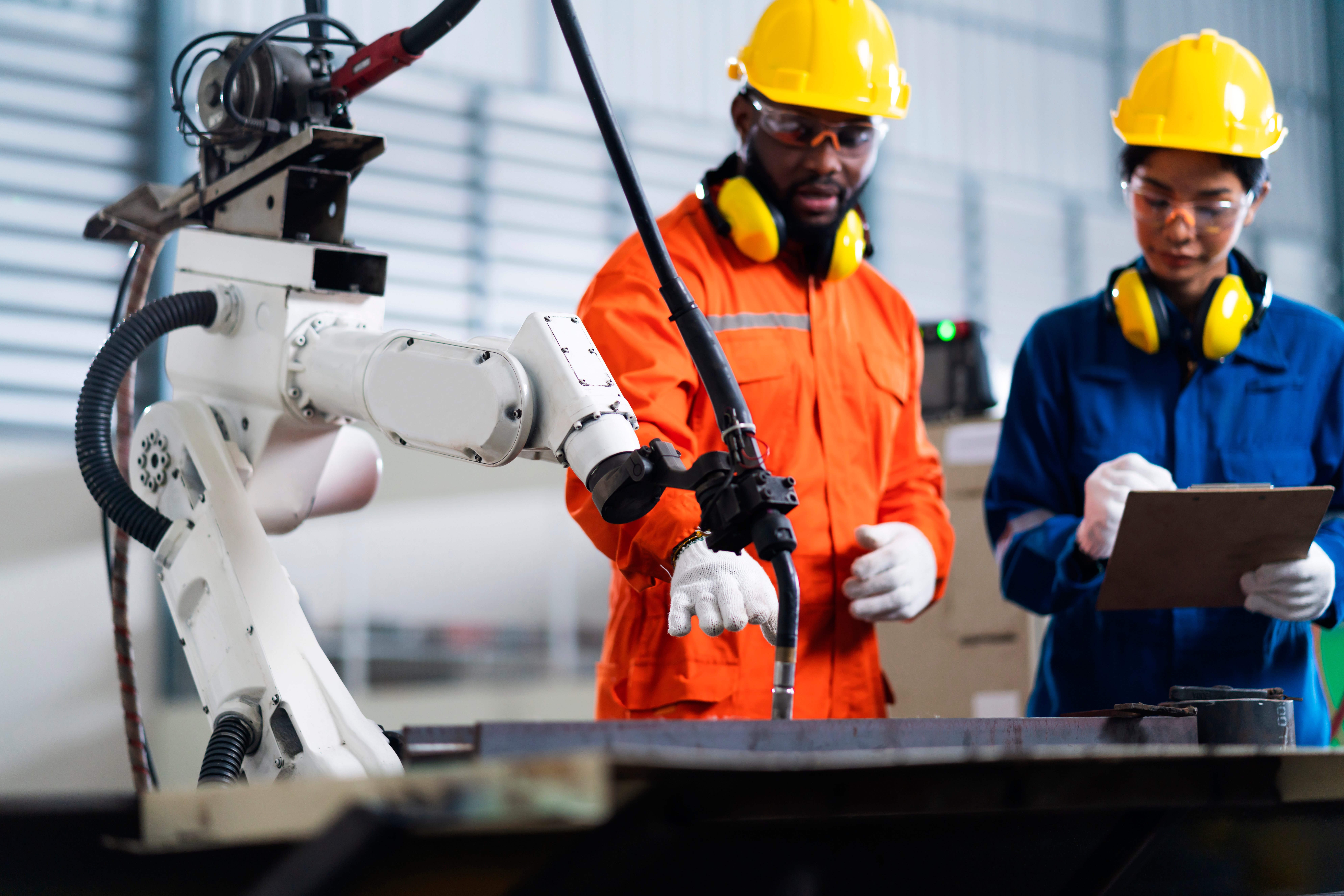 engineer-cooperation-male-female-technician-maintenance-control-relay-robot-arm-system-welding-with-tablet-laptop-control-quality-operate-process-work-heavy-industry-40-manufacturing-factory