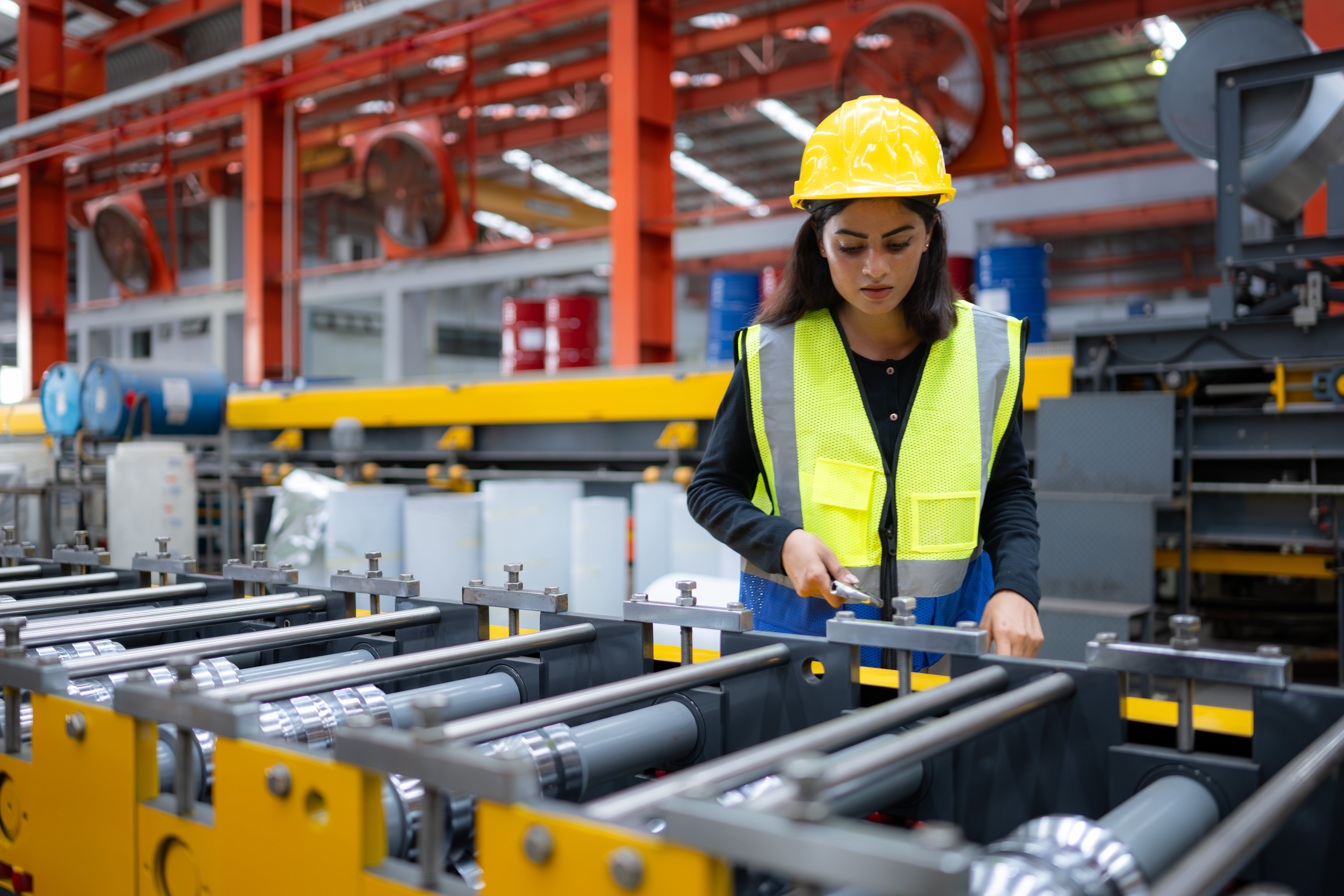 female-factory-technician-use-wrench-inspect-conveyor-belt-metal-sheet
