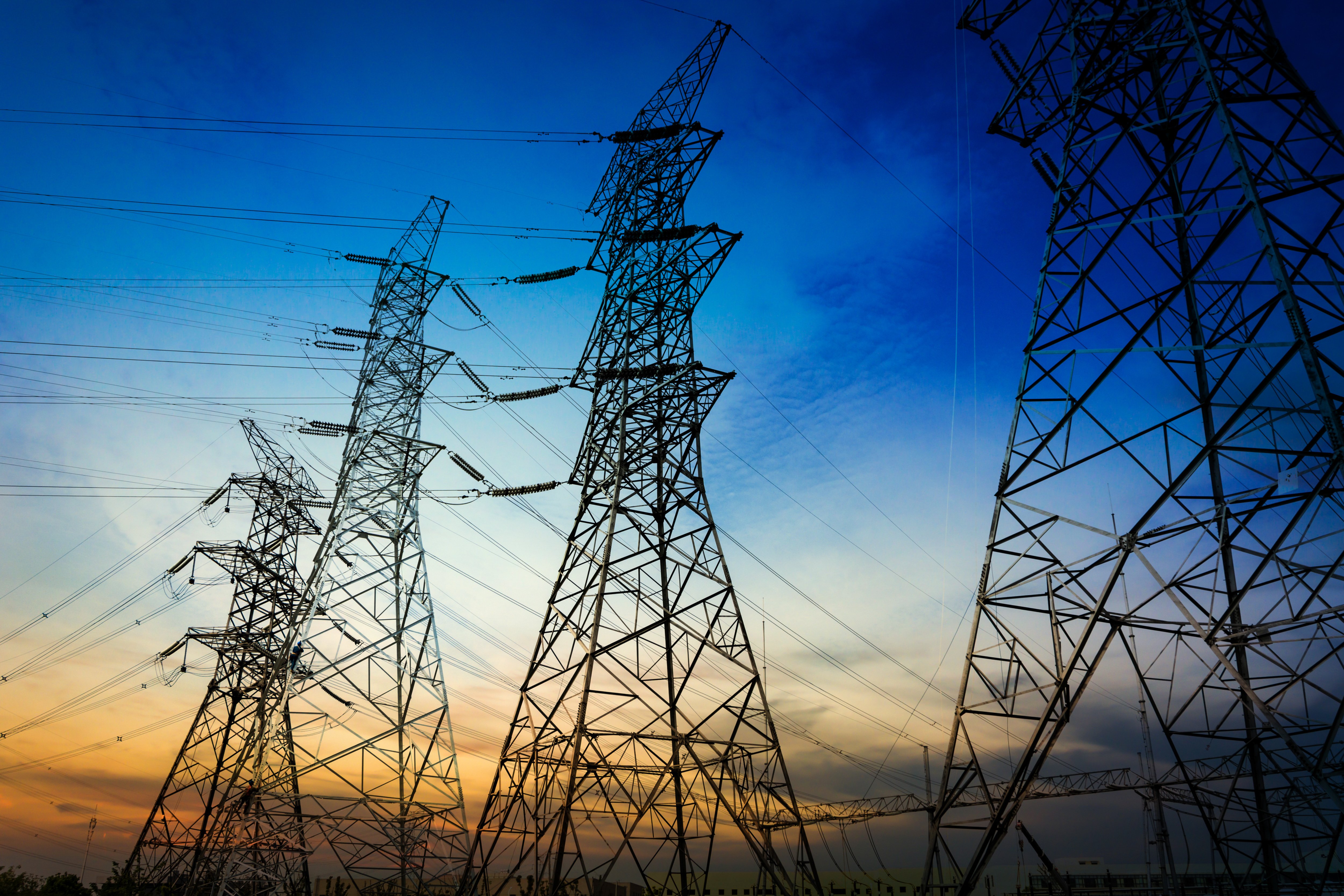 sun-setting-silhouette-electricity-pylons